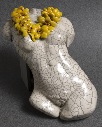 Image of torso sculpture with big yellow lei