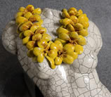 Close up of torso with yellow flower lei