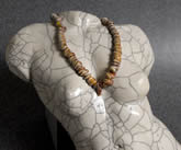 Close up of torso with puka shell lei